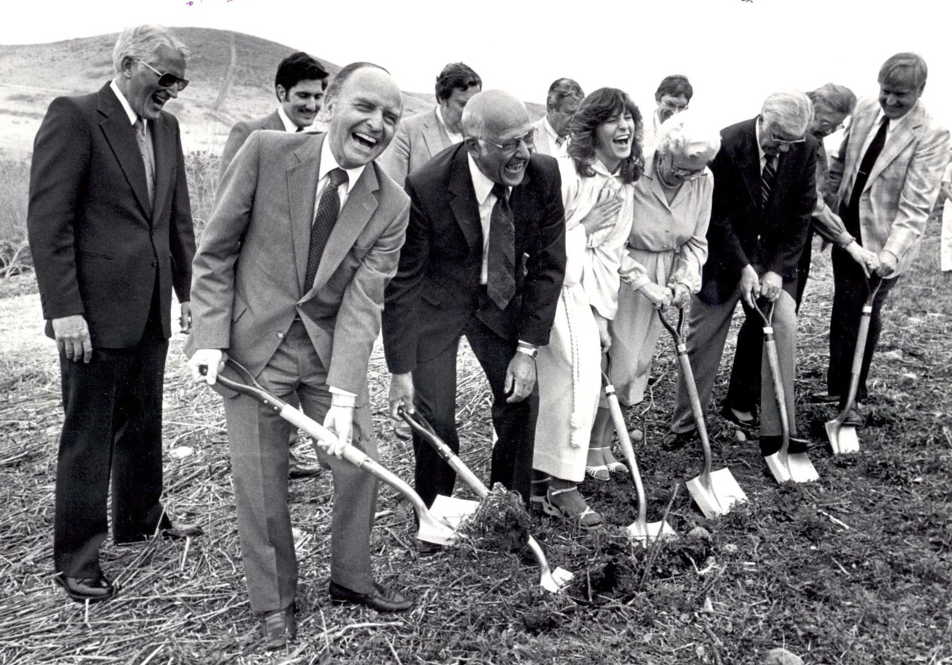 A group of people digging a hole in the ground