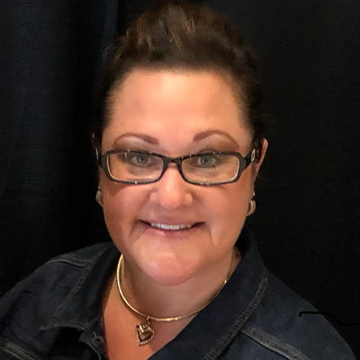 A woman wearing glasses and a necklace