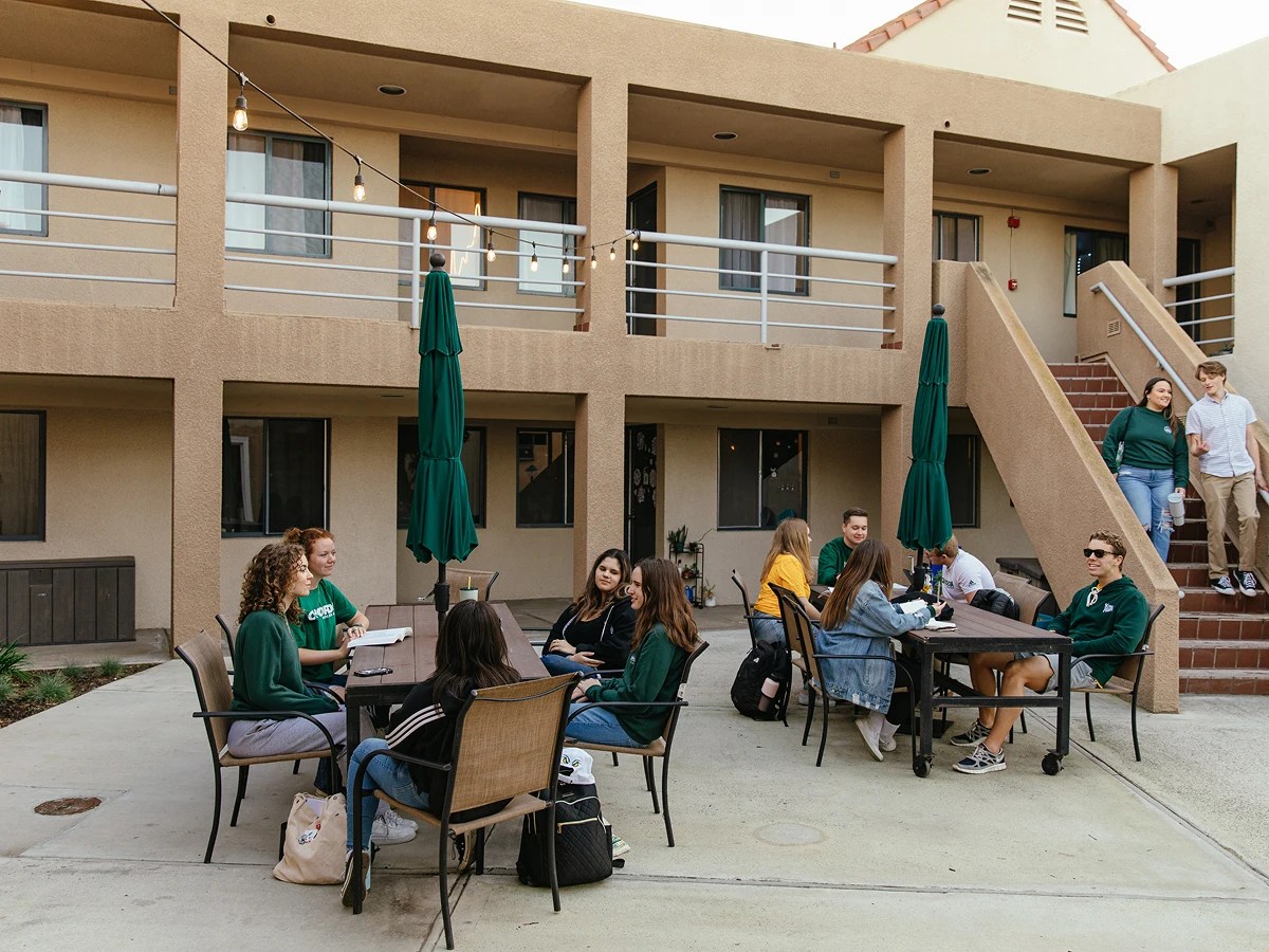 A group of people sitting outside a building