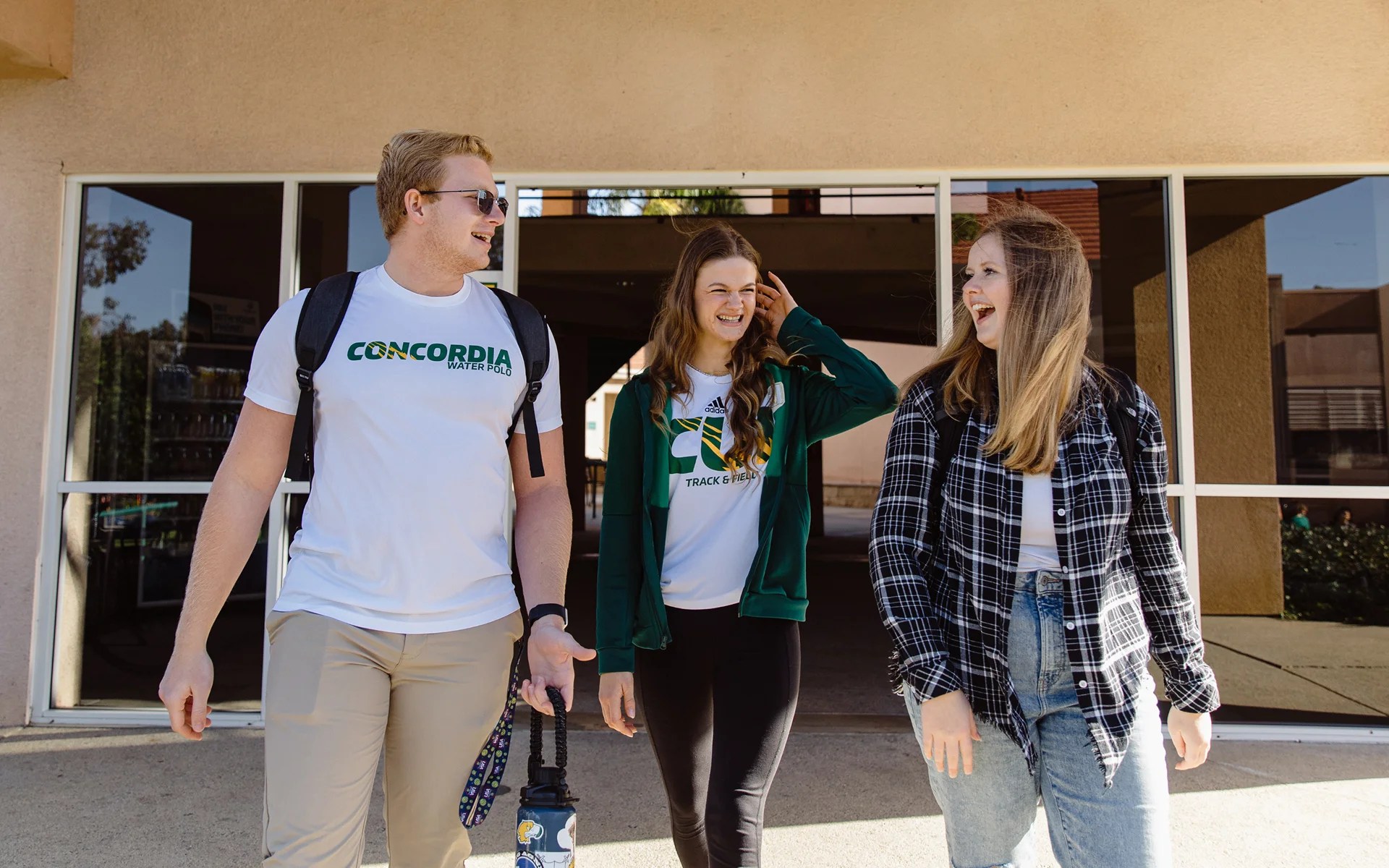 A group of people walking outside a building