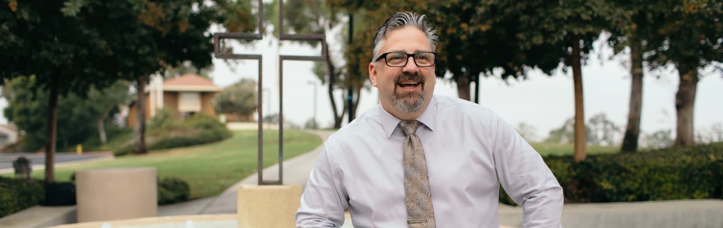 A man wearing glasses and a tie