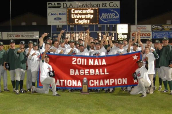 A group of baseball players holding a banner