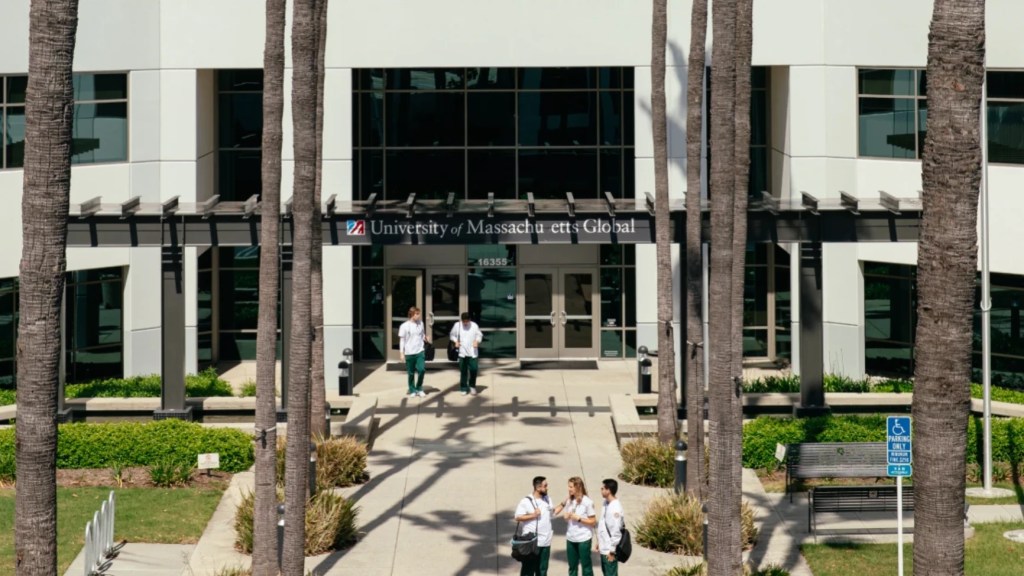 A group of people walking in front of a building