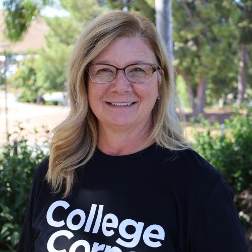A woman wearing glasses and a black shirt