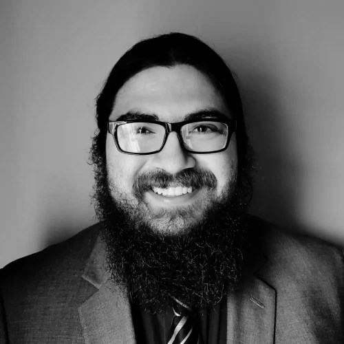 A man with a beard wearing glasses