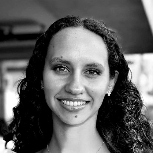 A woman with long curly hair smiling