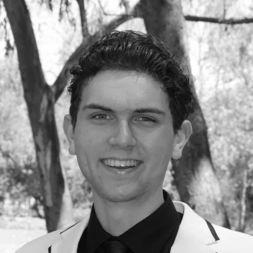 A man in a suit smiling
