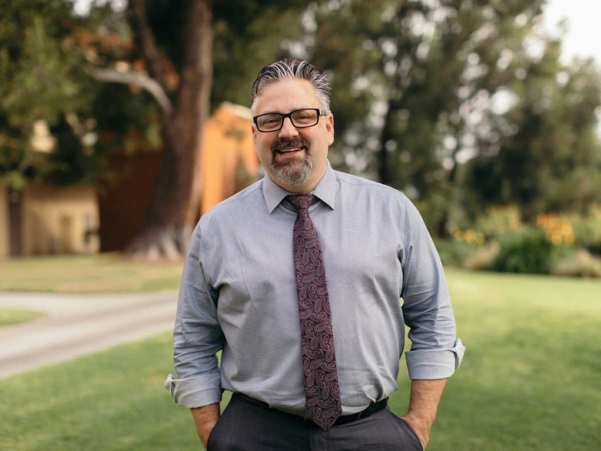 A man in a tie and glasses
