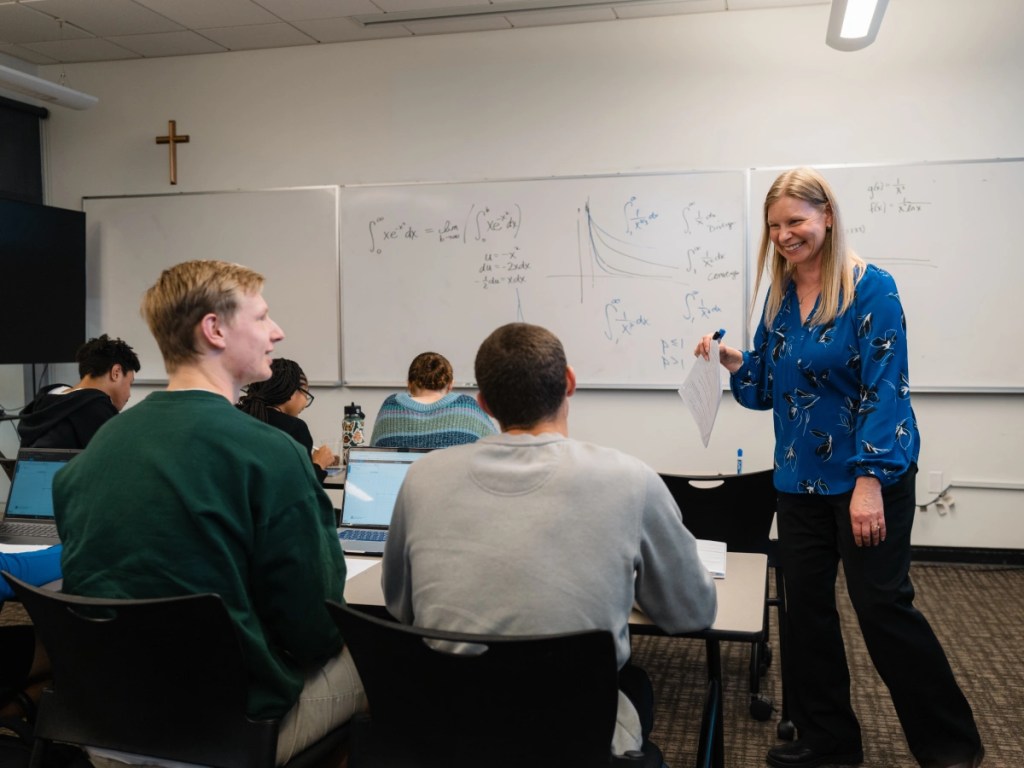 A woman standing in front of a whiteboard