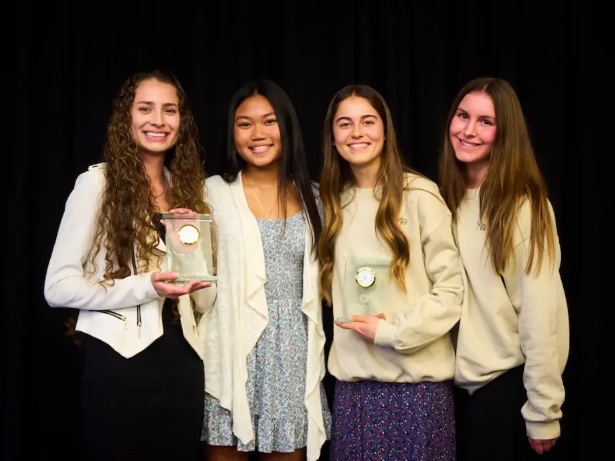 A group of women holding a trophy