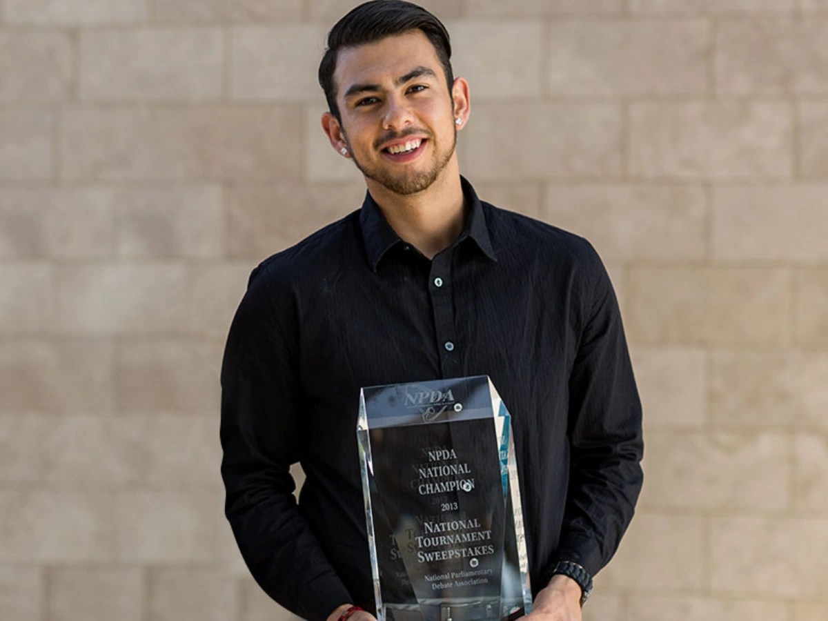 A man holding a trophy
