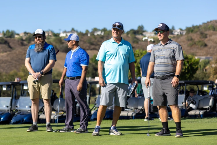 A group of men standing on a golf course