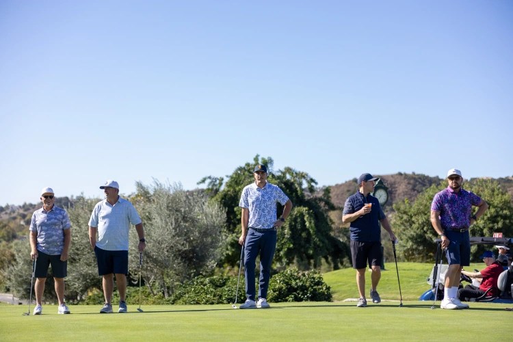 A group of men playing golf