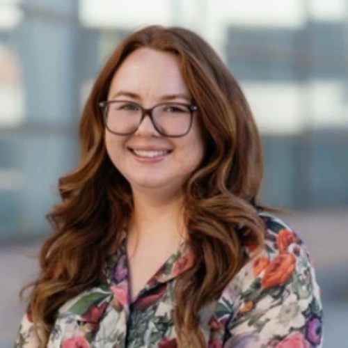 A woman with long hair wearing glasses