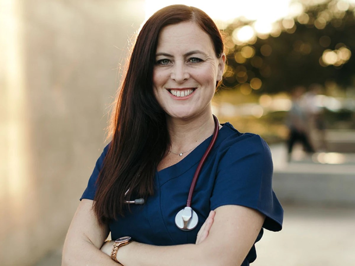 A woman wearing a blue scrubs