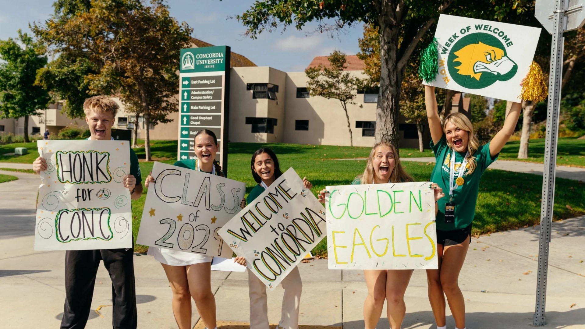 A group of young women holding signs