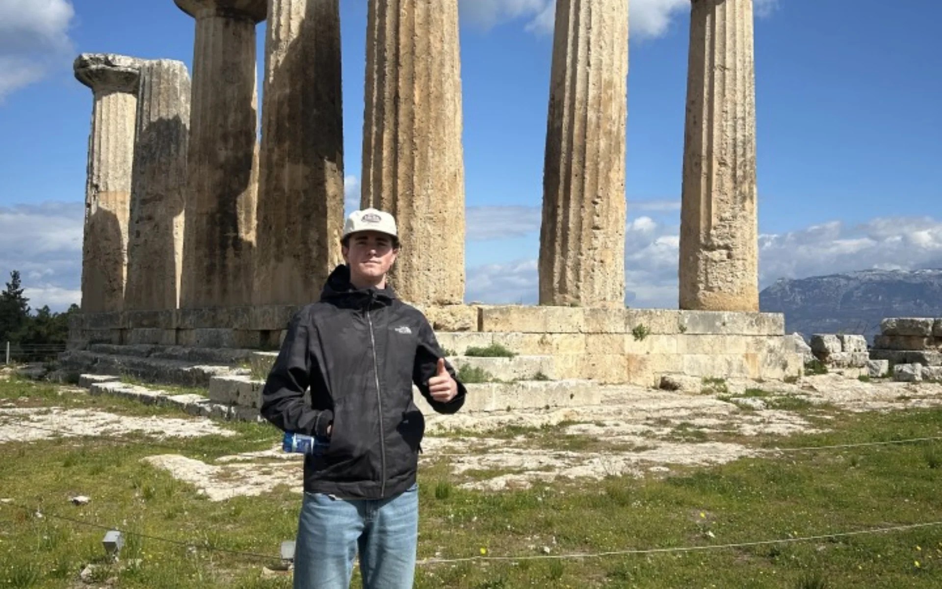 A man standing in front of a stone structure