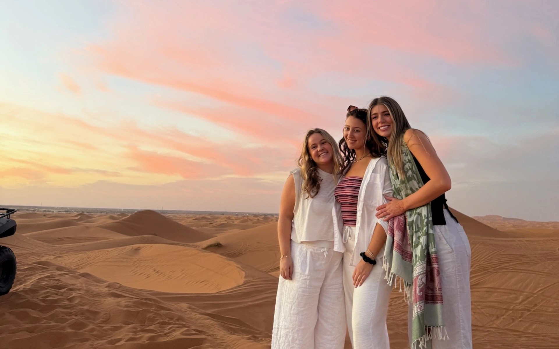 A group of women standing in a desert