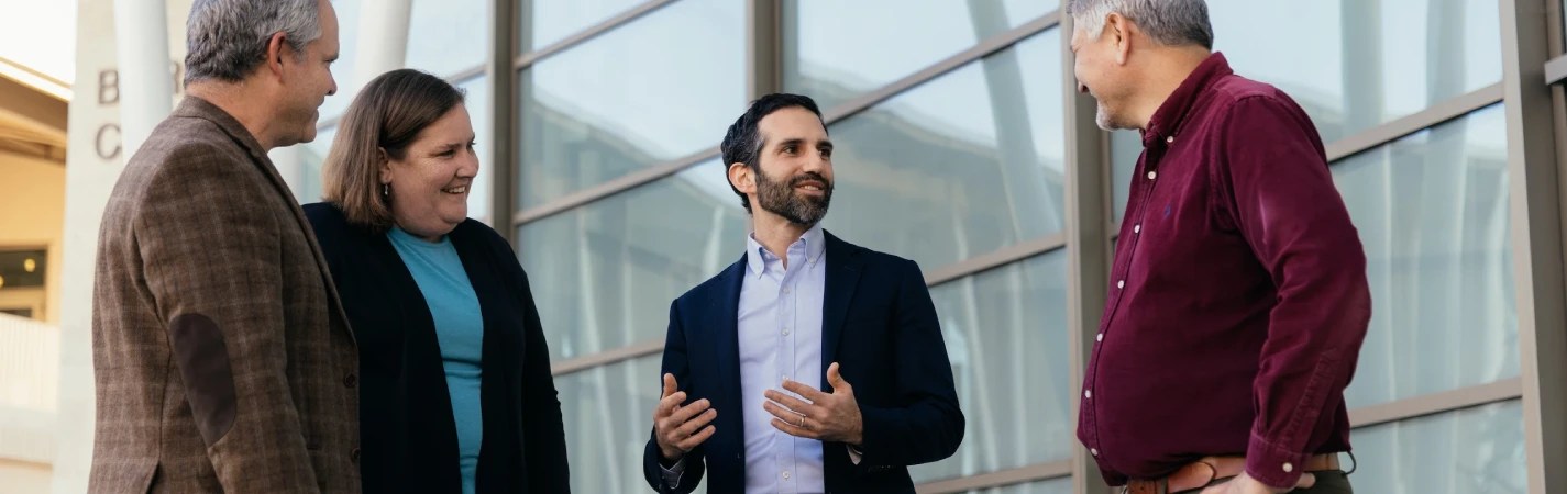 A man in a suit talking to another man