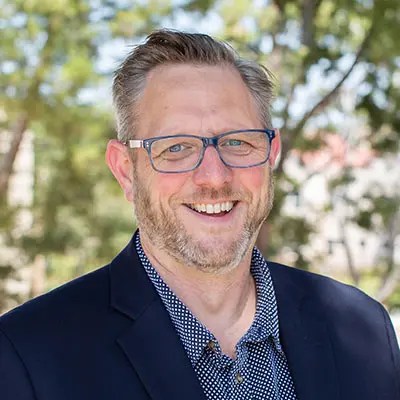 A man wearing a suit and glasses
