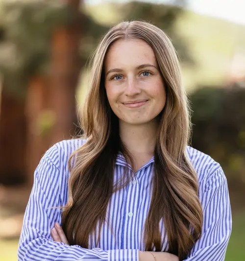 A woman with long hair wearing a striped shirt