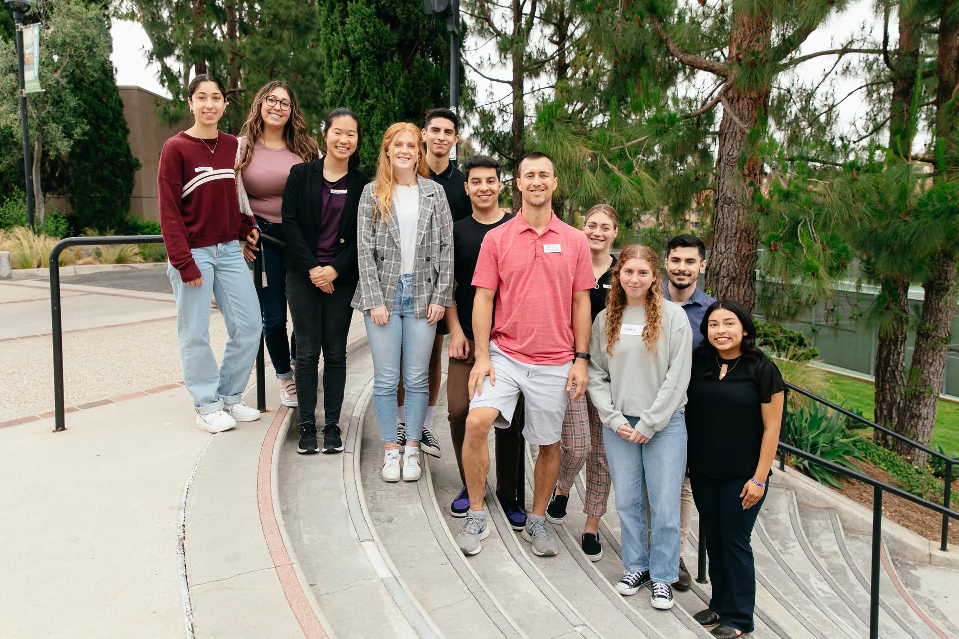 The LPLS research team standing together on outdoor steps on the Concordia University Irvine campus.