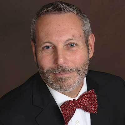 A man in a suit and bow tie