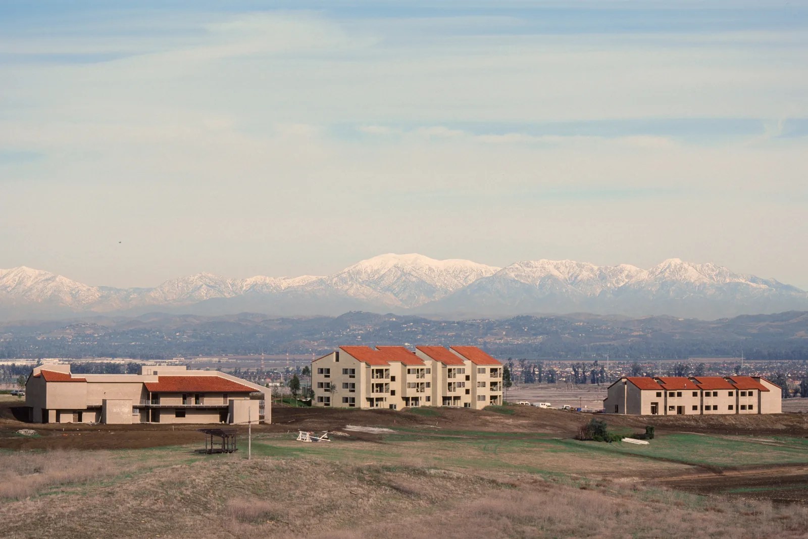The Bird Sanctuary and early campus buildings, with snow-capped mountains in the distance.