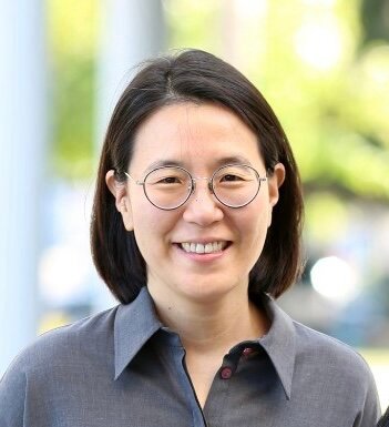 A woman wearing round glasses