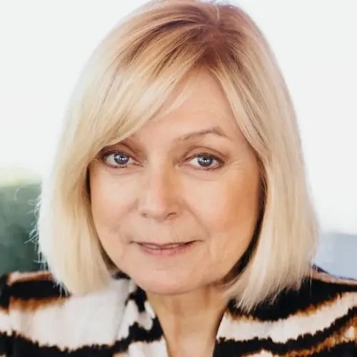 A woman with blonde hair wearing a zebra print jacket