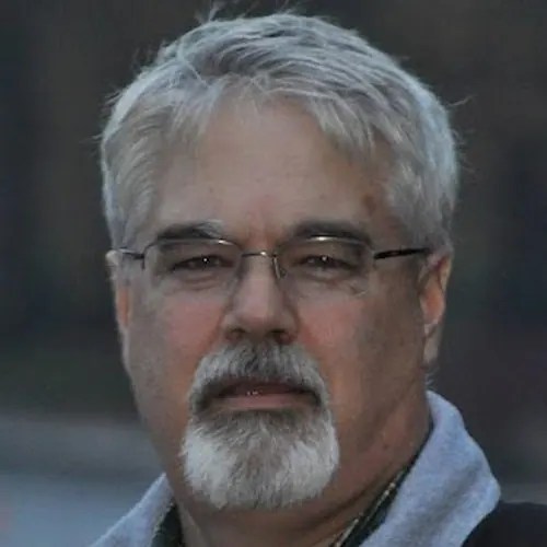 A man with glasses and a beard