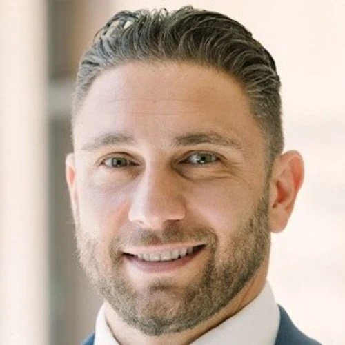 A man with a beard smiling