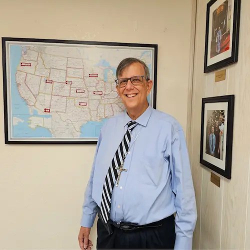 A man standing in front of a map